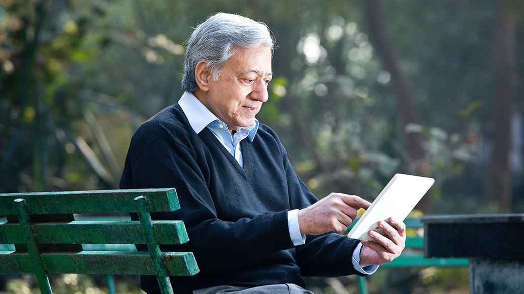 Epicor-Senior-Man-Using-Digital-Tablet-In-Park.jpg