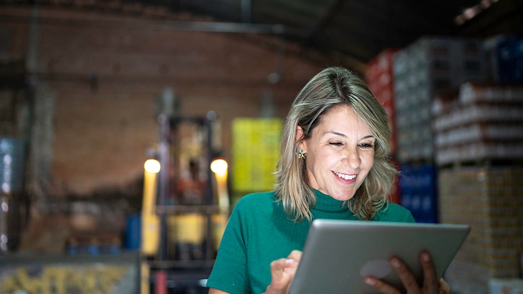 happy-employee-using-digital-tablet-at-warehouse.jpg